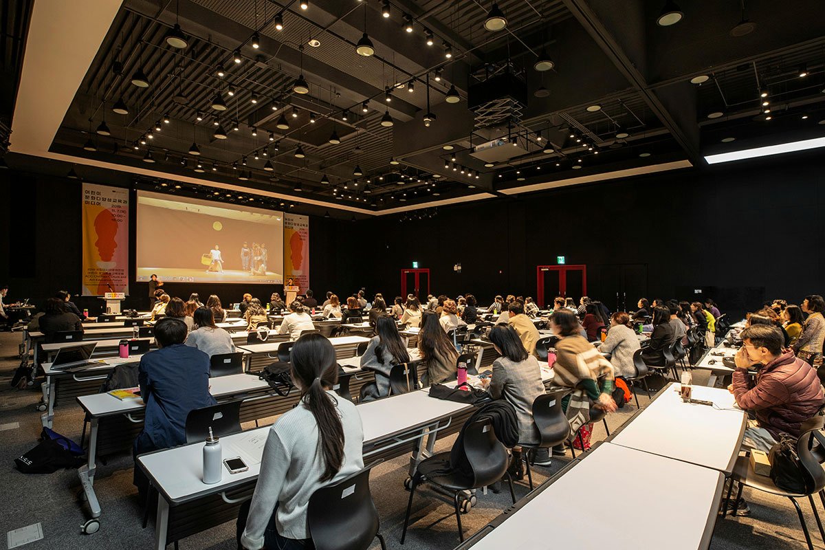 Image of an international conference with several people using translation equipment